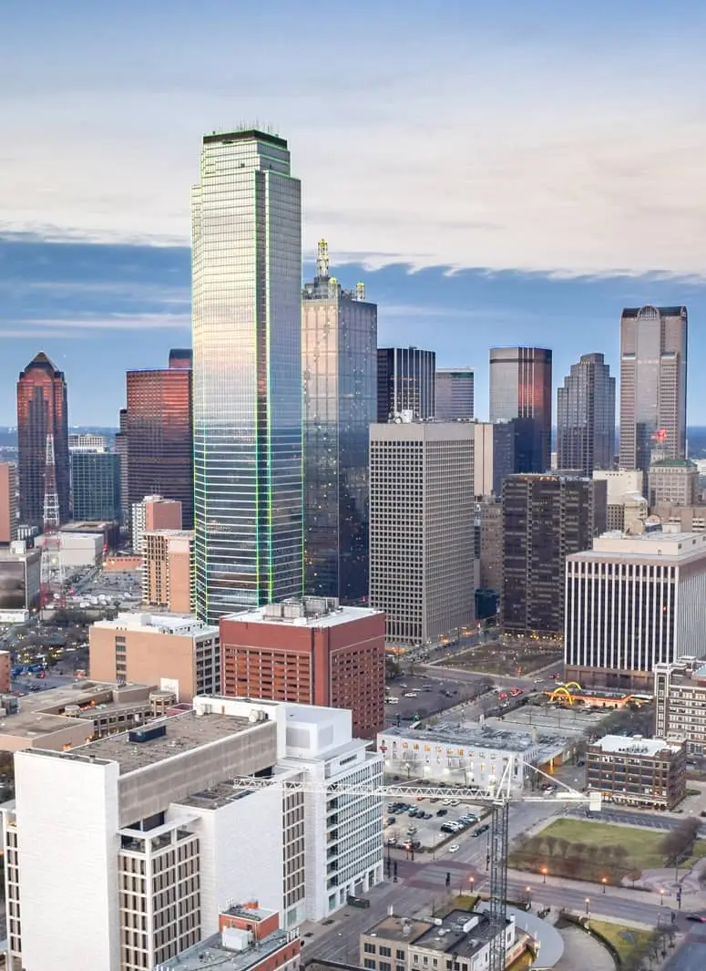 Downtown skyline dominated by a tall glass skyscraper surrounded by other high-rise buildings.