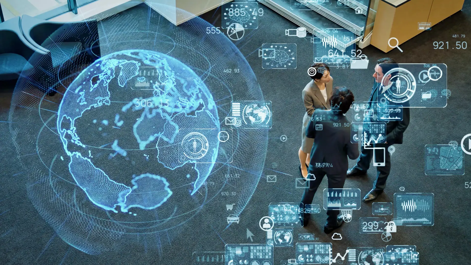 Globe projection overlapping people discussing, surrounded by digital interface icons, in an office.