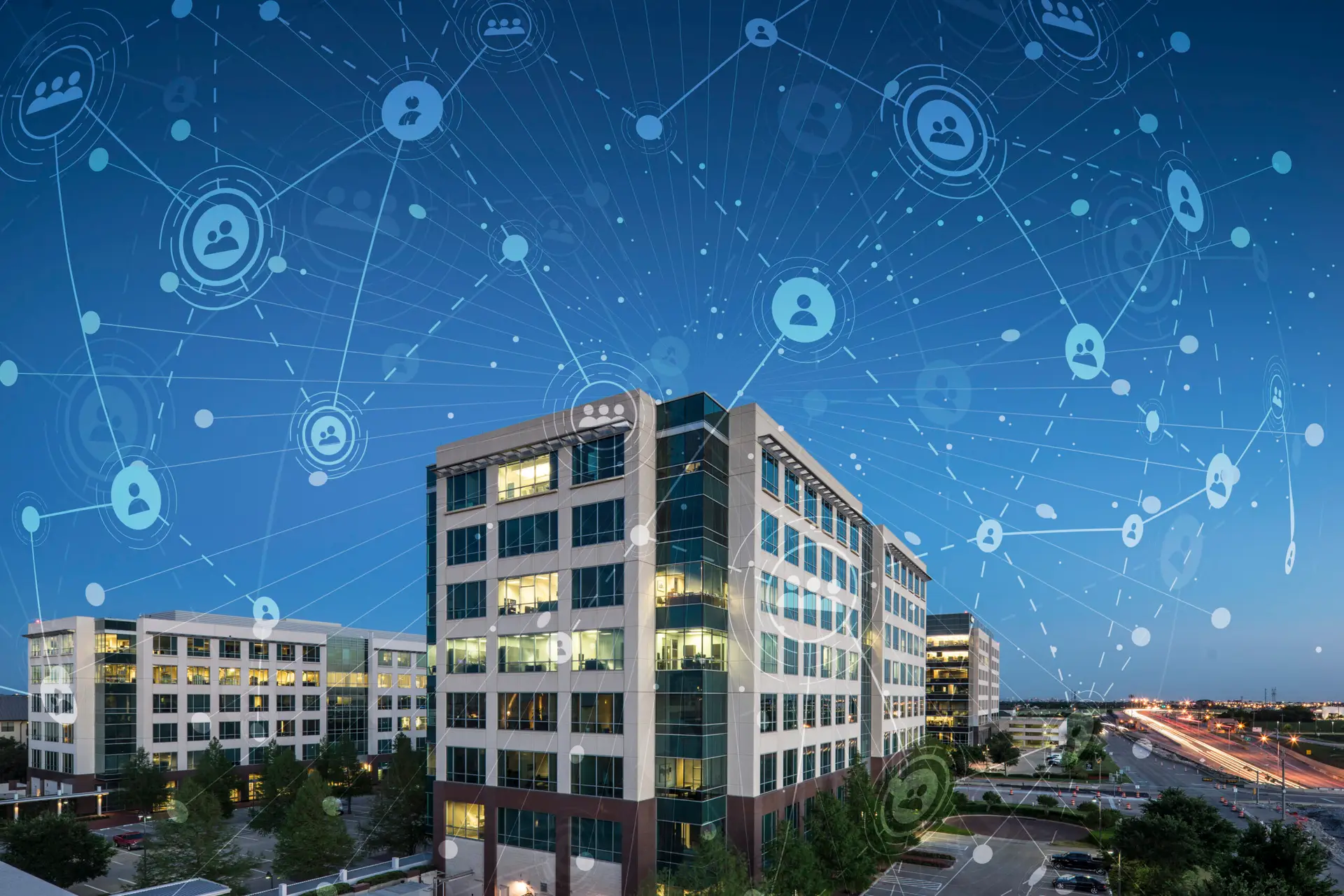Modern office buildings with a blue digital network overlay of interconnected user icons.