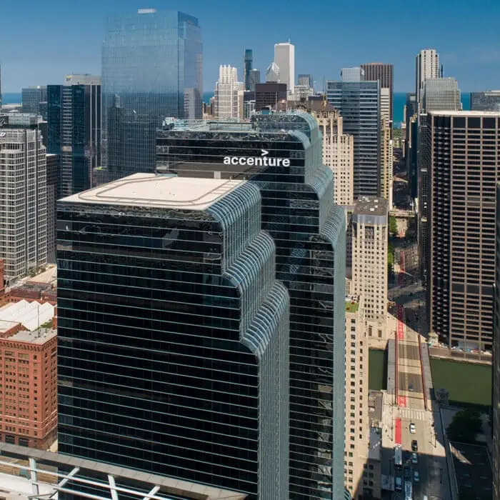 Accenture building stands amidst a cityscape. The building is a skyscraper with a prominent logo.