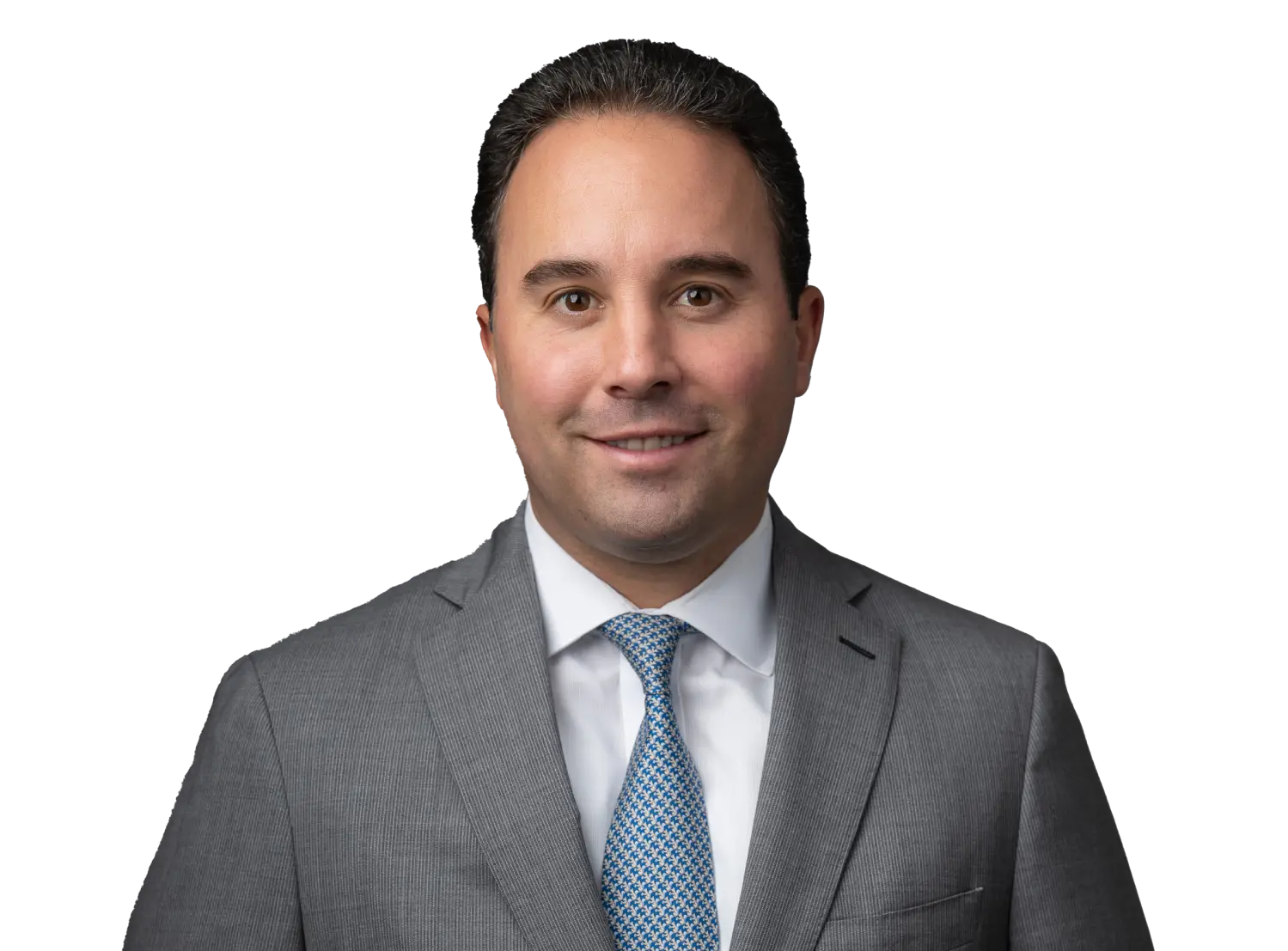 Portrait of a smiling man in a gray suit and blue patterned tie against a black background.