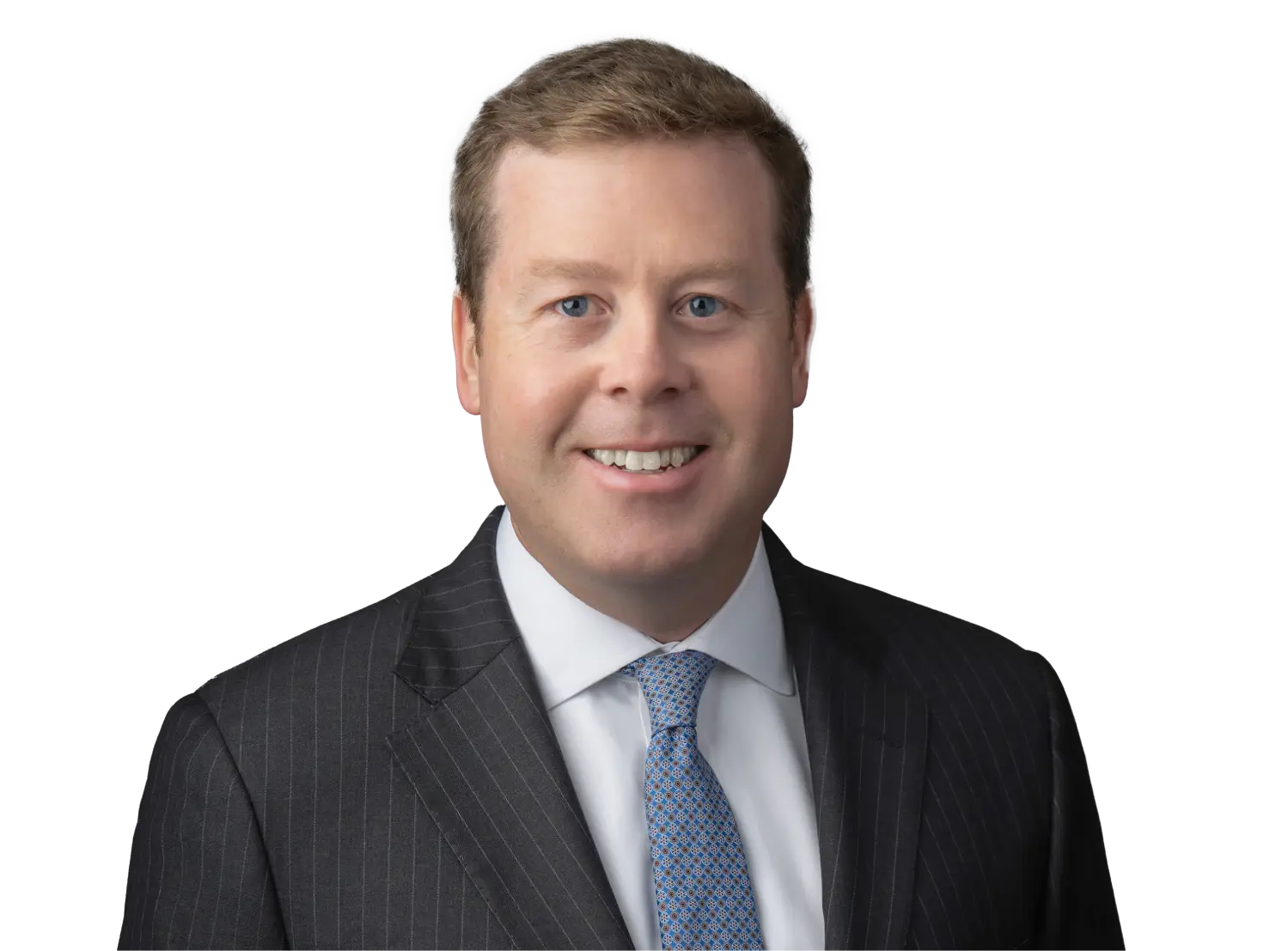 Smiling man in a dark pinstripe suit and light blue tie.