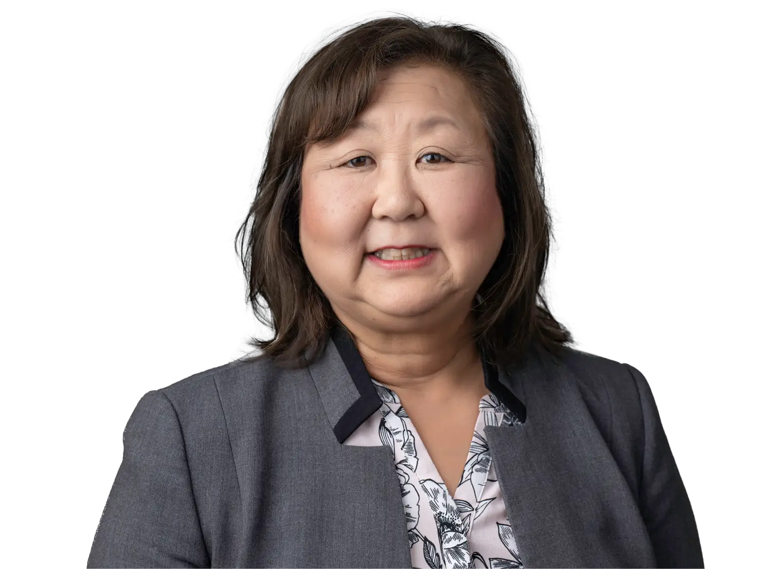Portrait of a smiling Asian woman in a gray blazer and floral blouse.