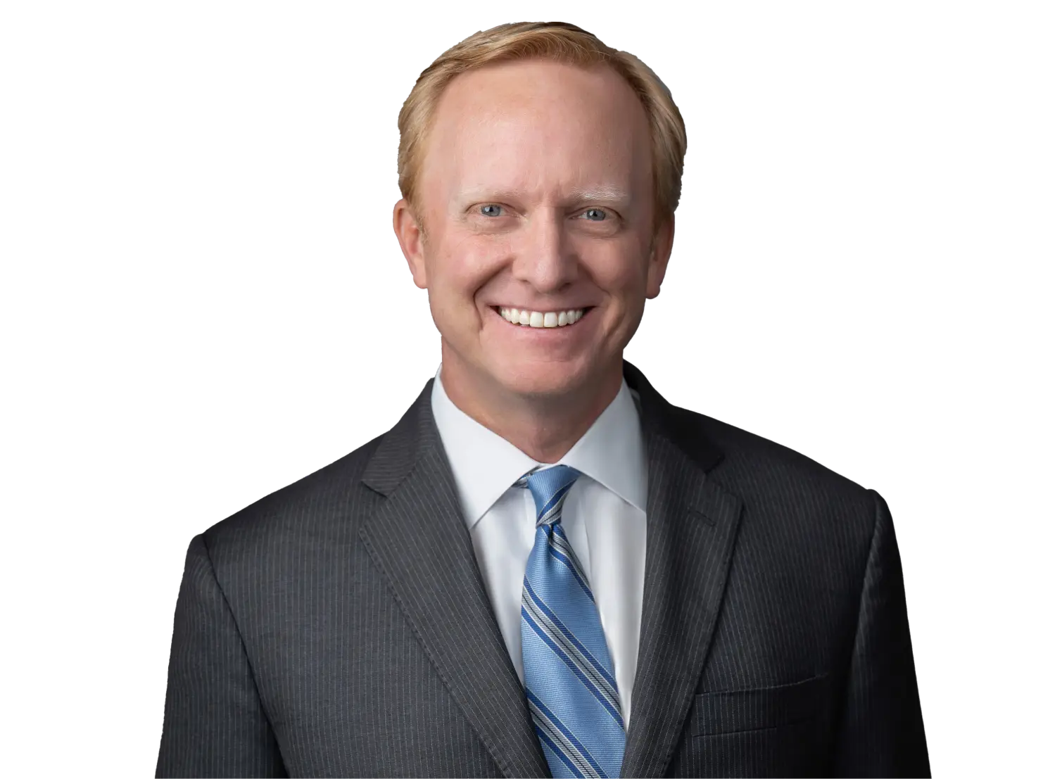 Portrait of a smiling man in a dark pinstripe suit and blue striped tie against a black background.