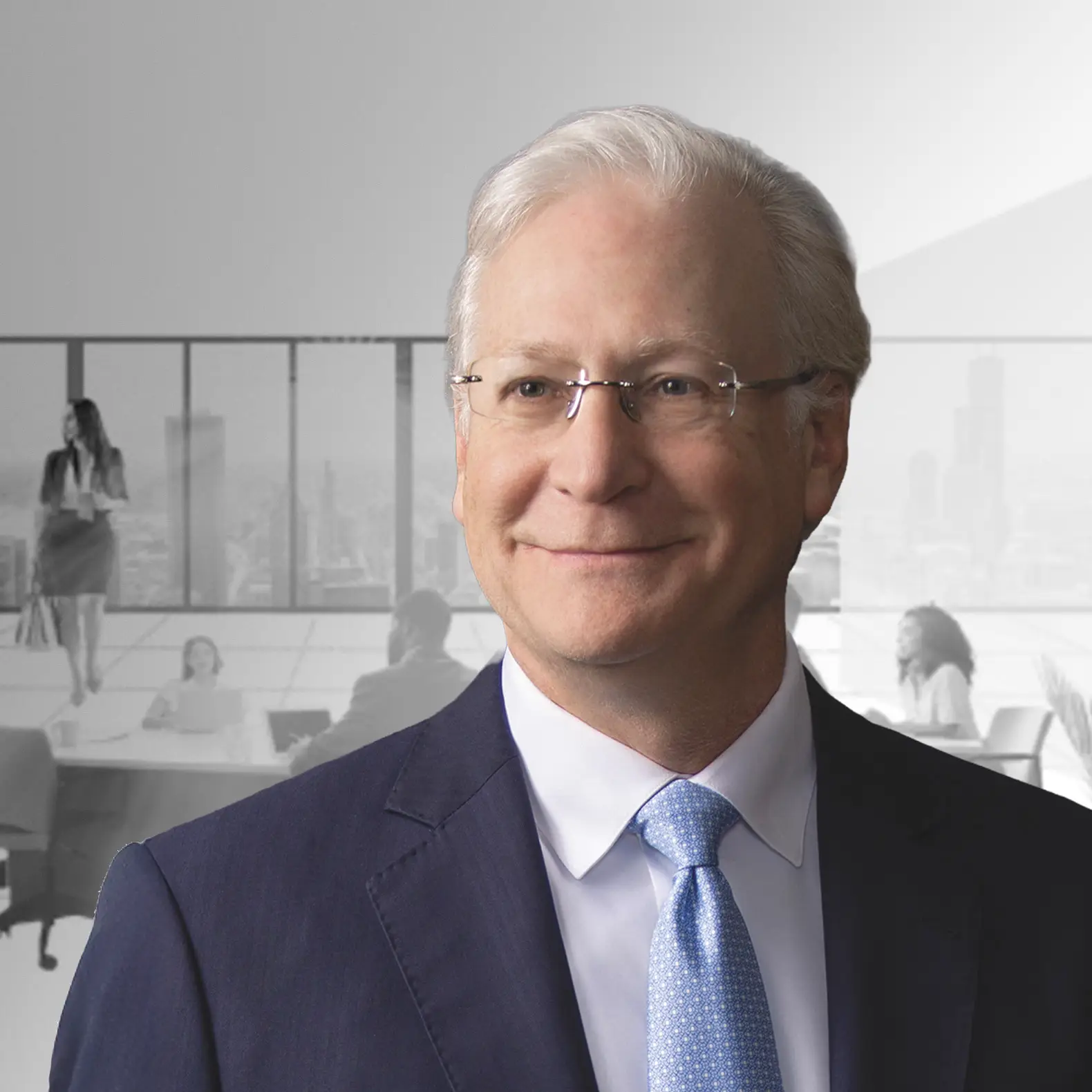 Man in suit and glasses smiling; office meeting background with cityscape view.